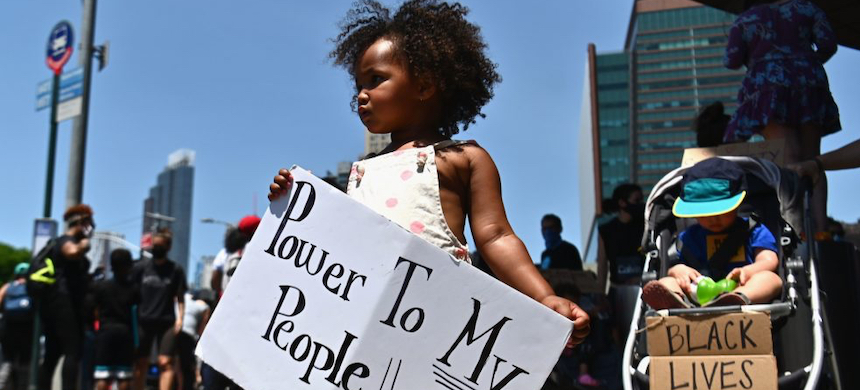 A child holds a poster during a Black Lives Matter rally.