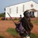 A soldier patrols by a Central African church