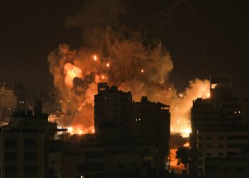 Fire and smoke rise above buildings in Gaza City during an Israeli airstrike